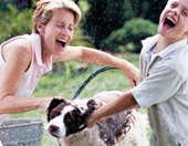 family washing their dog